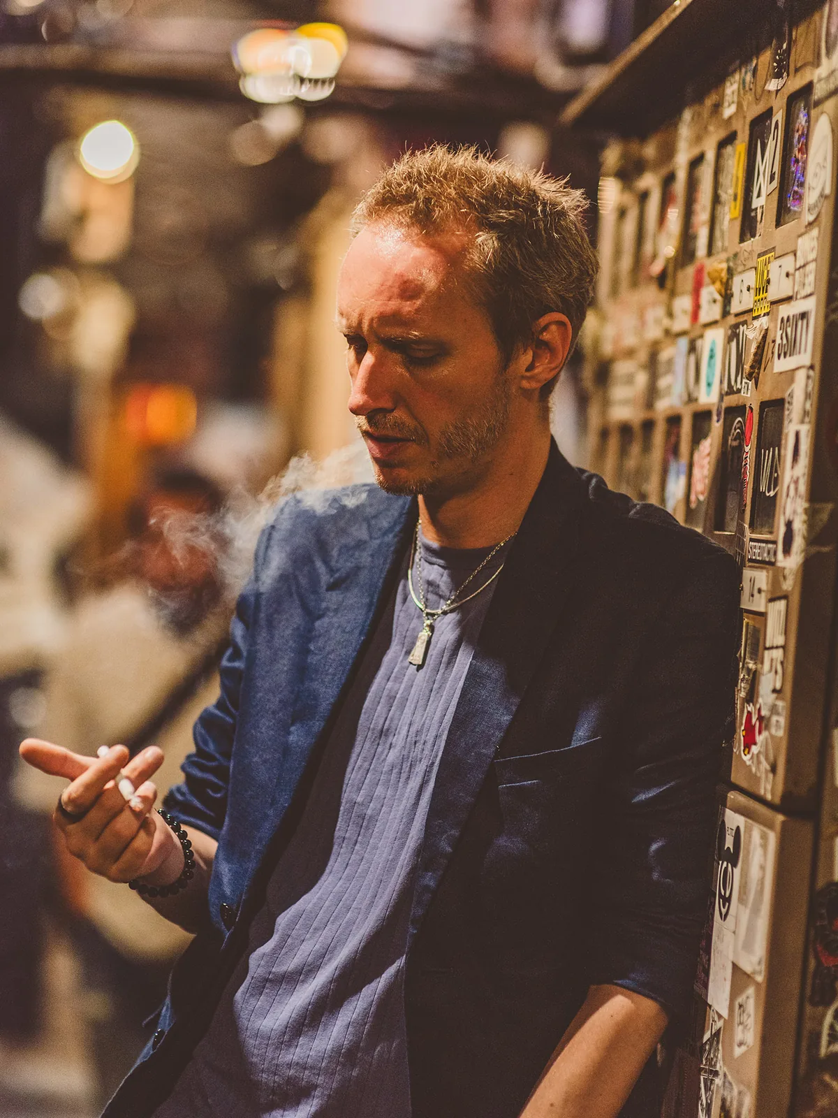 Philip Zeplin standing against a wall of records and posters in Tokyo.